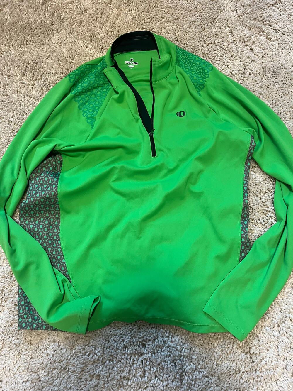 Pearl Izumi green long sleeve quarter zip cycling jersey with geometric side pan